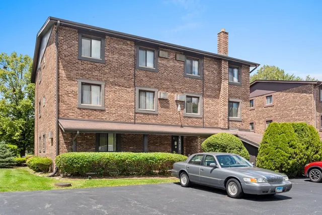 a car parked in front of a brick house