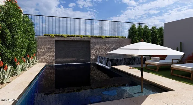 a view of a patio with table and chairs under an umbrella with a small yard