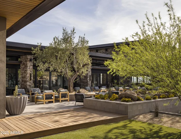 a outdoor space with lots of tables a large window and chairs