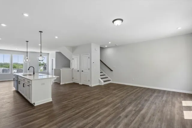 a kitchen with a sink cabinets and wooden floor