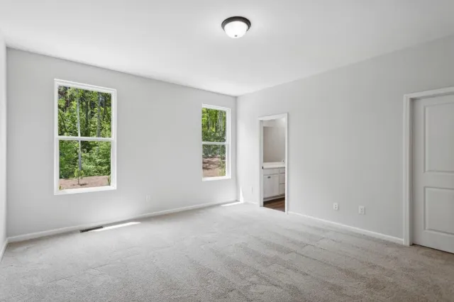 an empty room with windows and closet