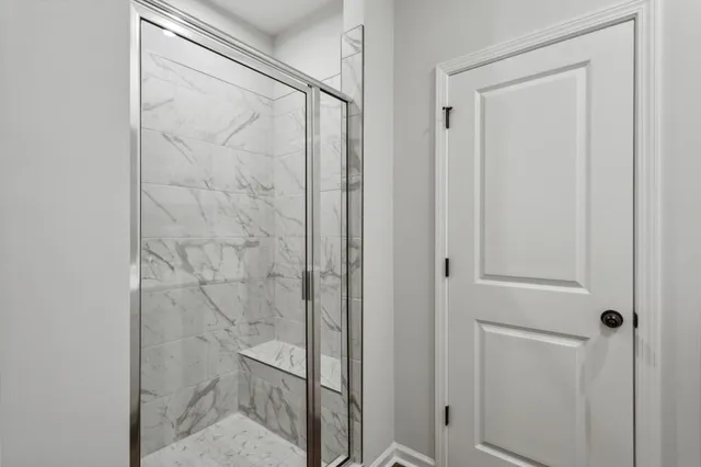 a bathroom with a glass shower door