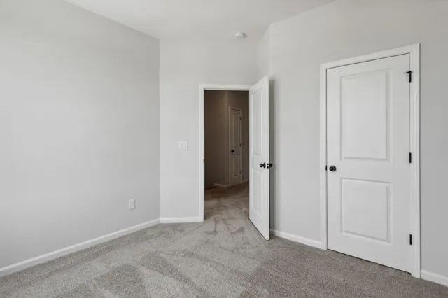 a view of an empty room with closet area