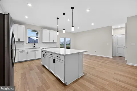 a kitchen with a sink window stainless steel appliances and cabinets