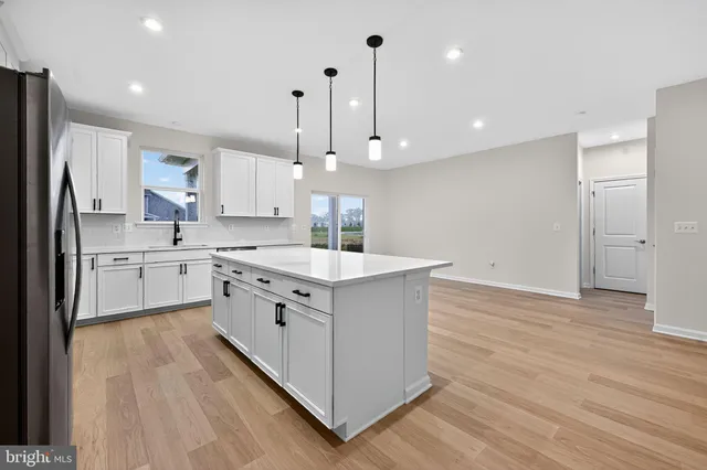 a kitchen with a sink window stainless steel appliances and cabinets