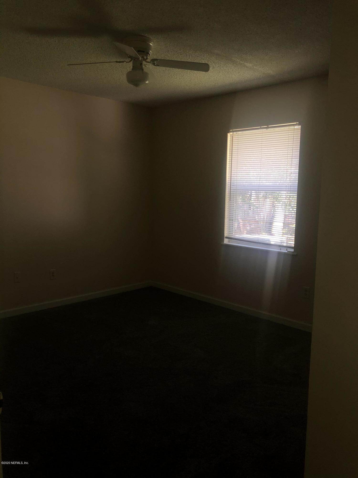 141 Jasmine Street Atlantic Beach, FL 32233 - Photo 13 of 23 a view of a livingroom with an empty space and a window