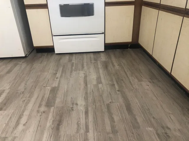 a view of a room with wooden floor