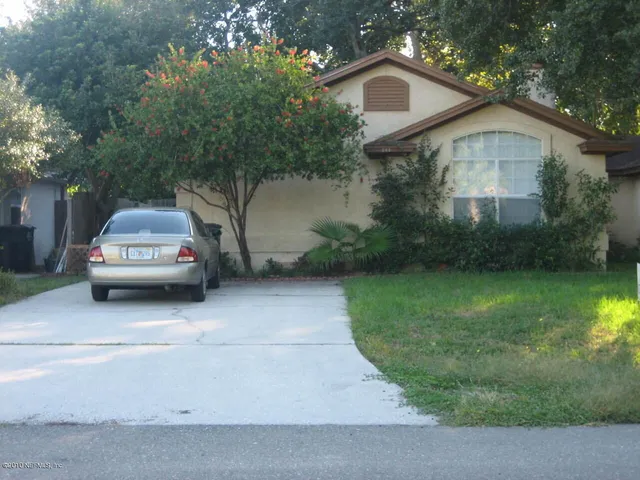 a car parked in front of white house