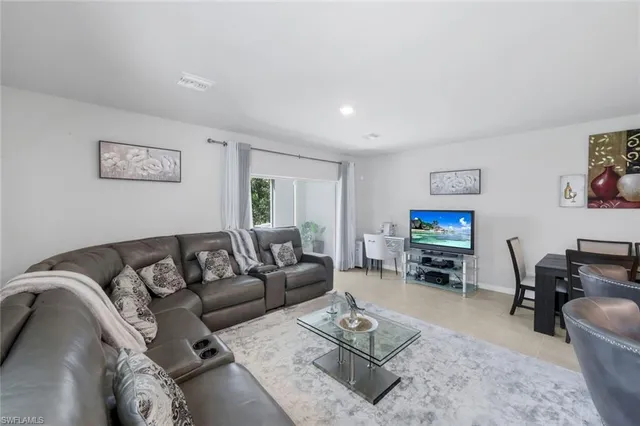 a living room with furniture a rug and a flat screen tv