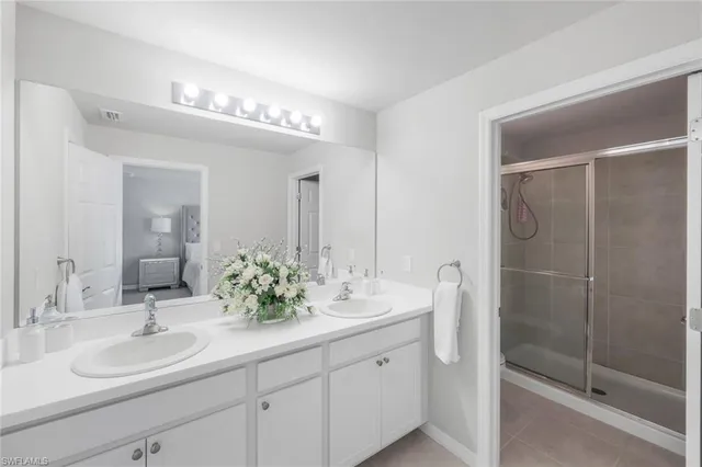 a bathroom with double vanity sinks and a mirror