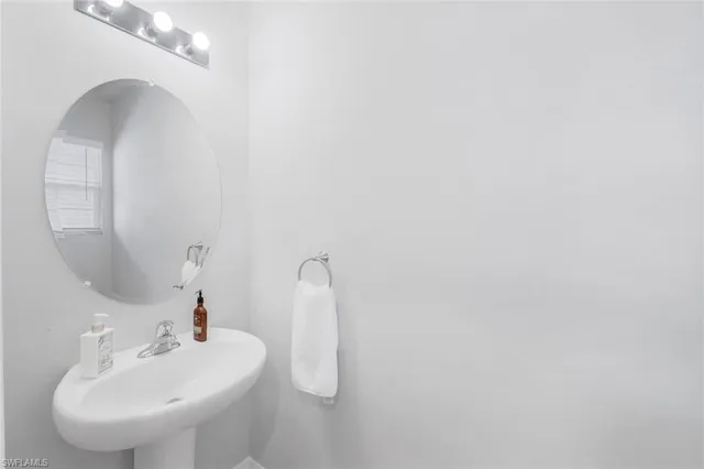 a bathroom with a sink and mirror