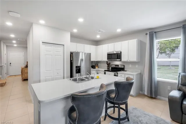 a kitchen with refrigerator a sink and a refrigerator