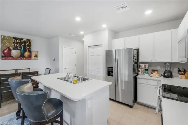 a kitchen that has a table and chairs in it
