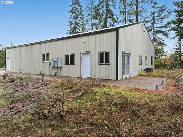 a backyard of a house with large tree and wooden fence