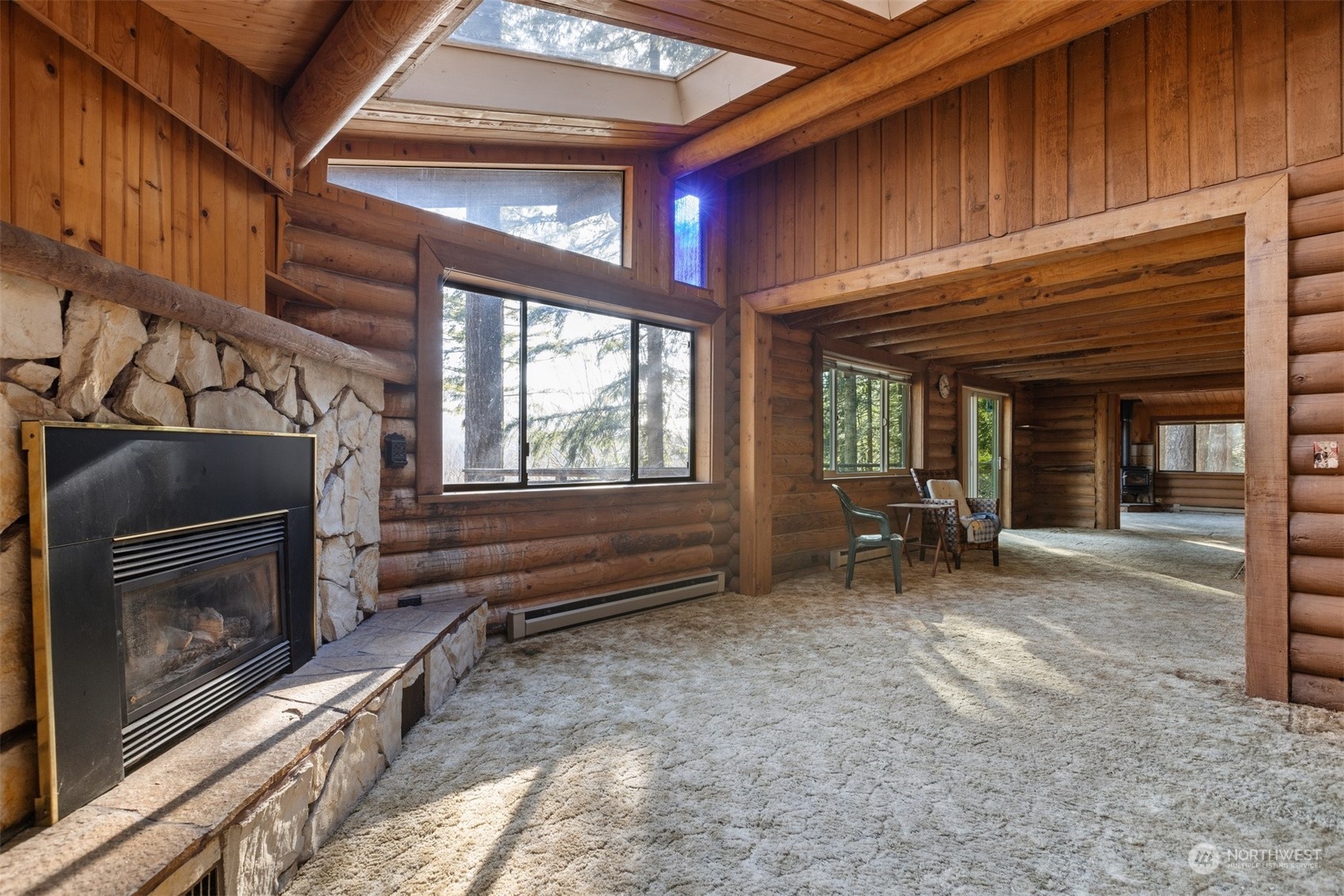 7527 Cemetery Road Maple Falls, WA 98266 - Photo 21 of 40 a view of an empty room with wooden floor and a fireplace