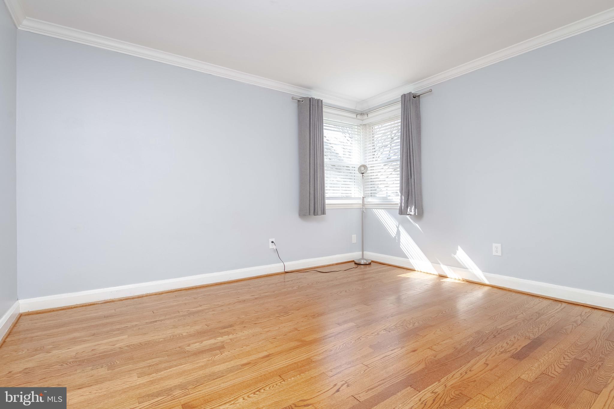 7012 Dunhill Road Dundalk, MD 21222 - Photo 13 of 38 a view of an empty room with wooden floor and a window