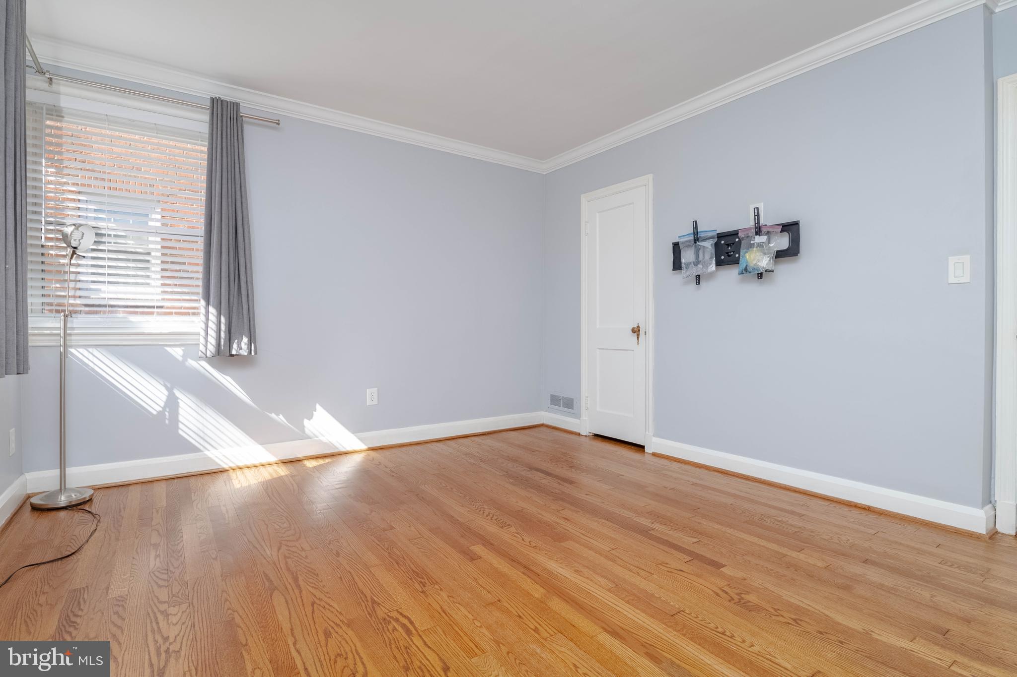7012 Dunhill Road Dundalk, MD 21222 - Photo 14 of 38 an empty room with wooden floor and windows