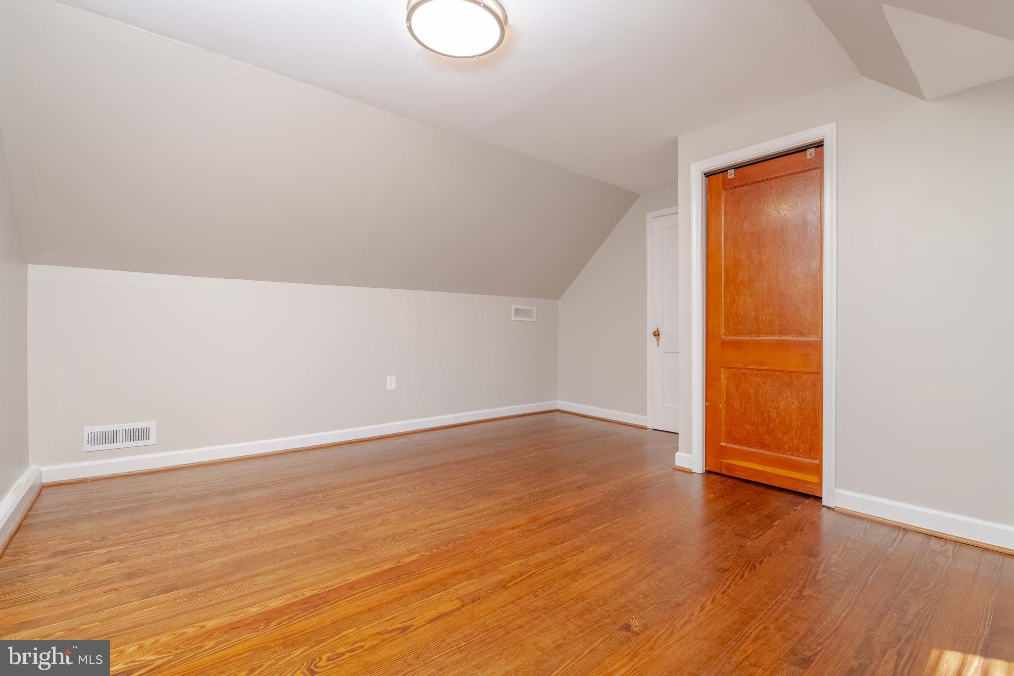 7012 Dunhill Road Dundalk, MD 21222 - Photo 24 of 38 an empty room with wooden floor and windows