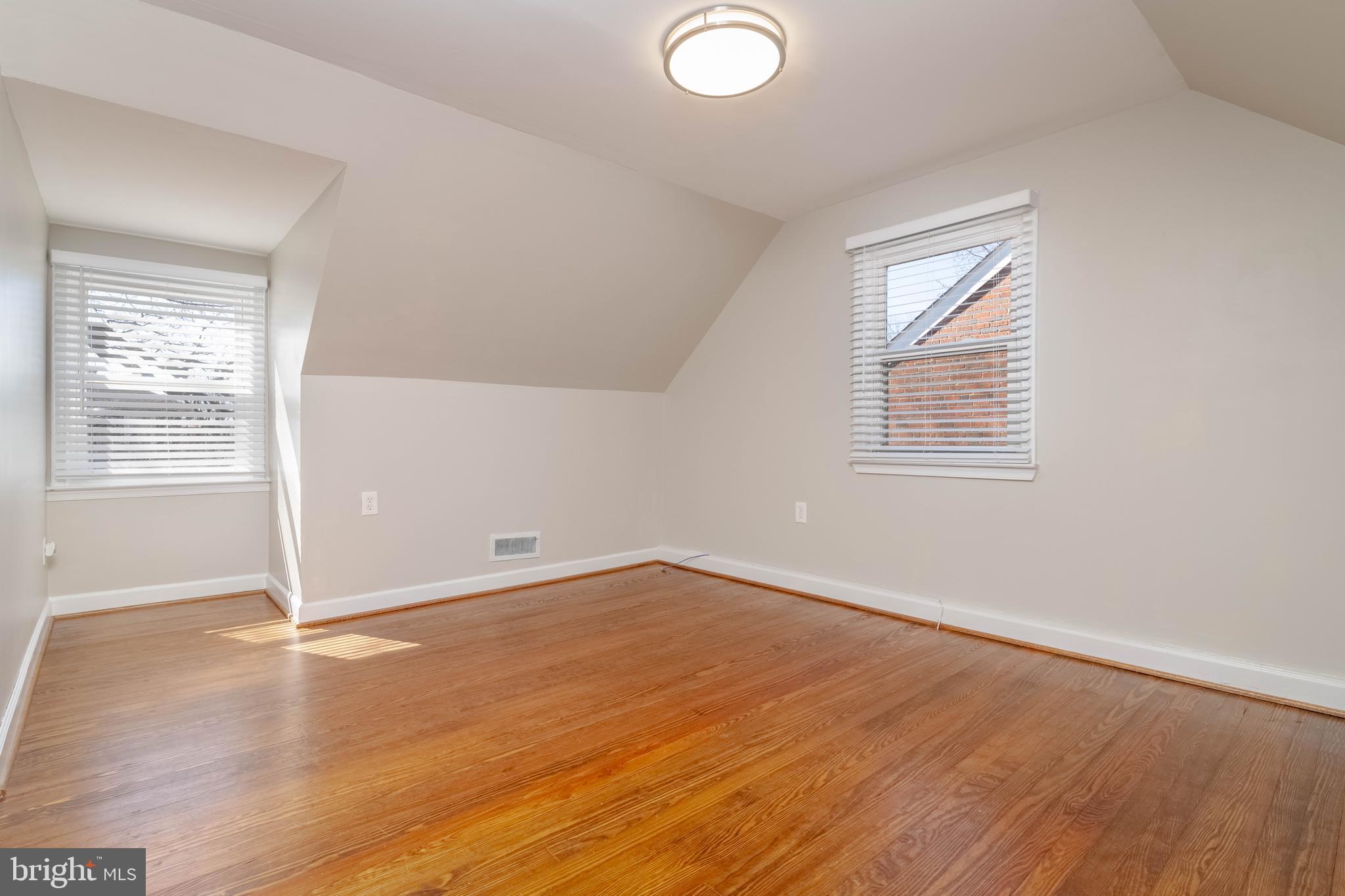 7012 Dunhill Road Dundalk, MD 21222 - Photo 25 of 38 an empty room with wooden floor and windows