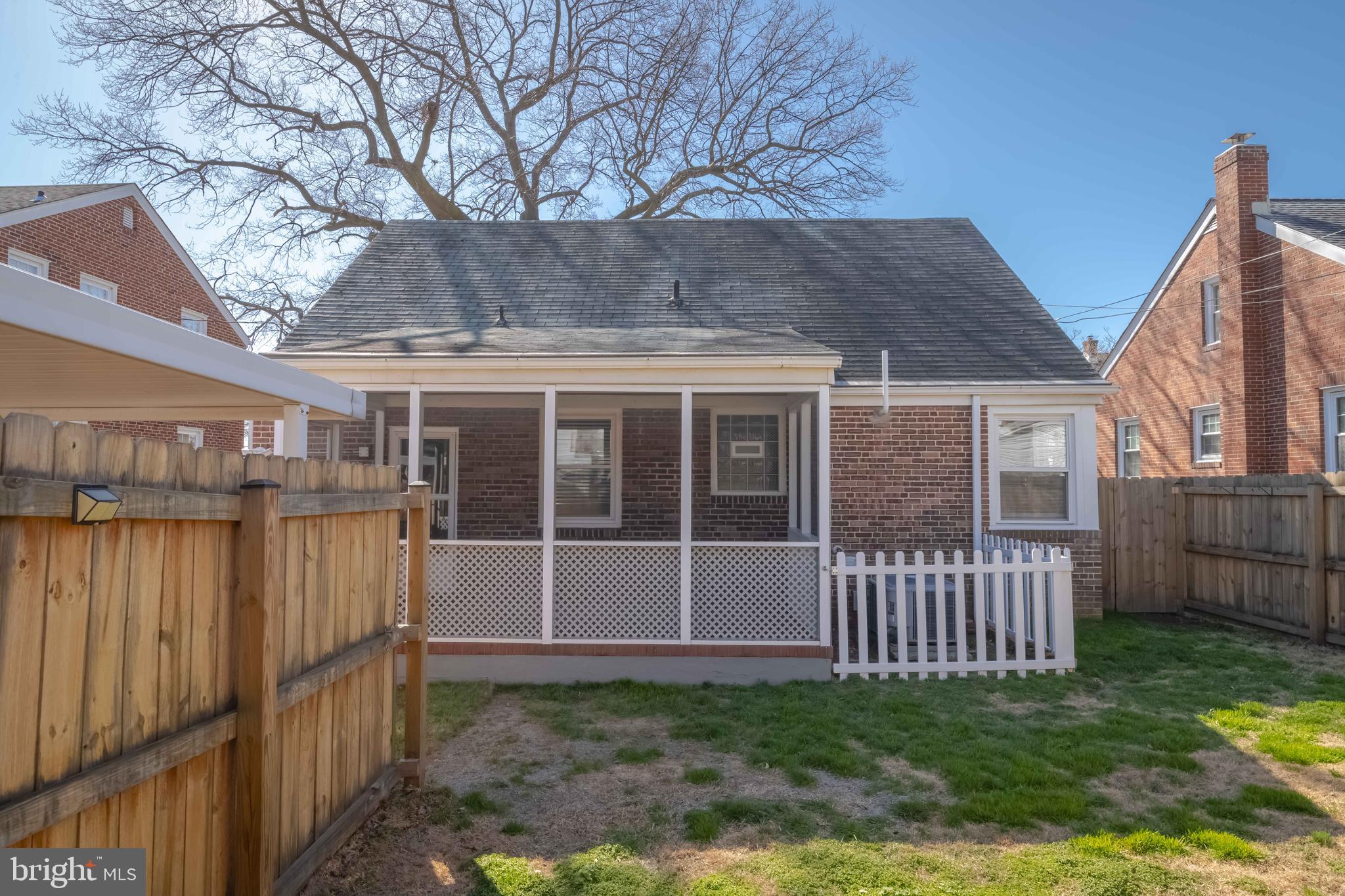 7012 Dunhill Road Dundalk, MD 21222 - Photo 35 of 38 a view of a house with a yard and wooden fence