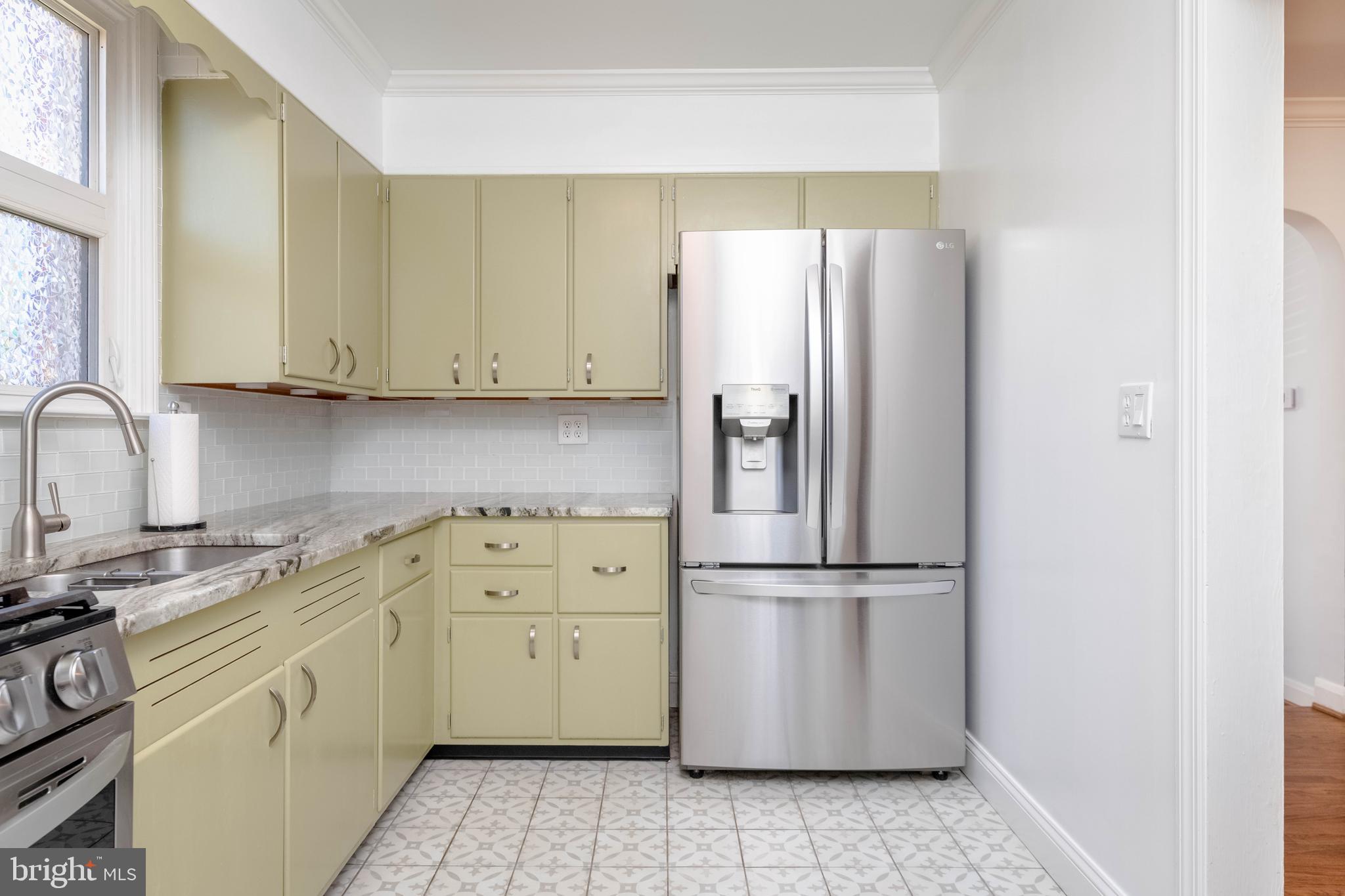 7012 Dunhill Road Dundalk, MD 21222 - Photo 4 of 38 a kitchen with a refrigerator sink and cabinets