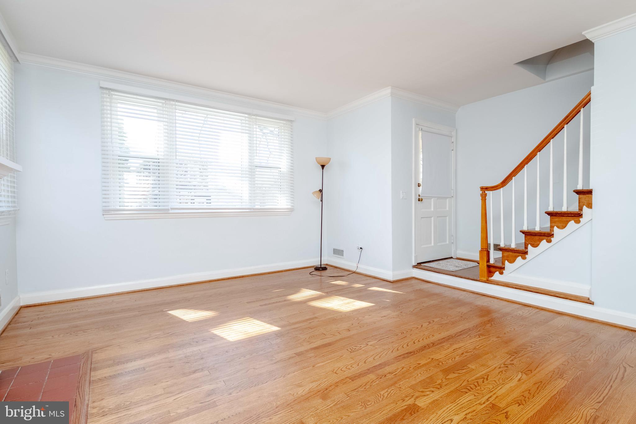 7012 Dunhill Road Dundalk, MD 21222 - Photo 8 of 38 a view of an empty room with wooden floor and a window