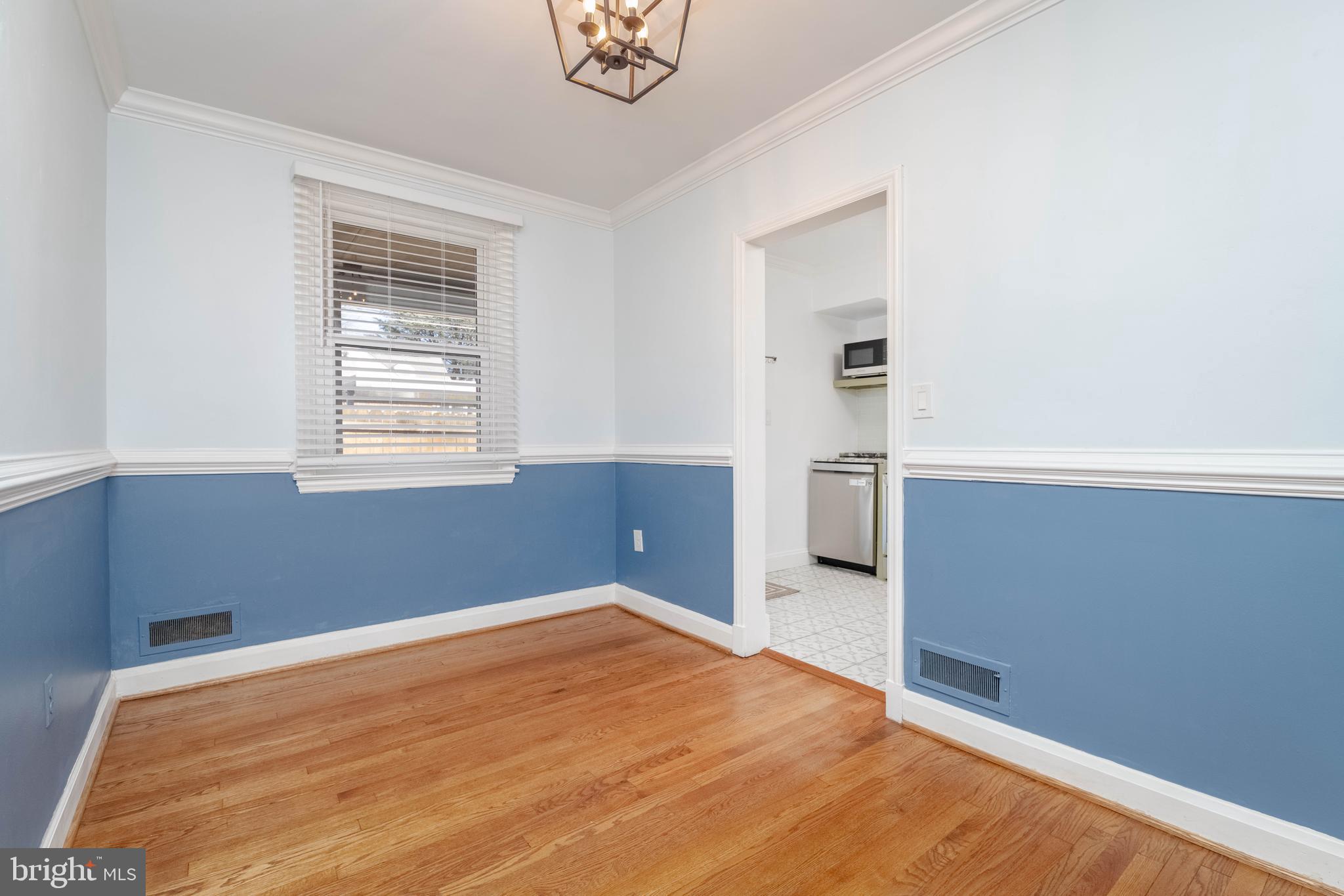 7012 Dunhill Road Dundalk, MD 21222 - Photo 9 of 38 a view of empty room with wooden floor and window
