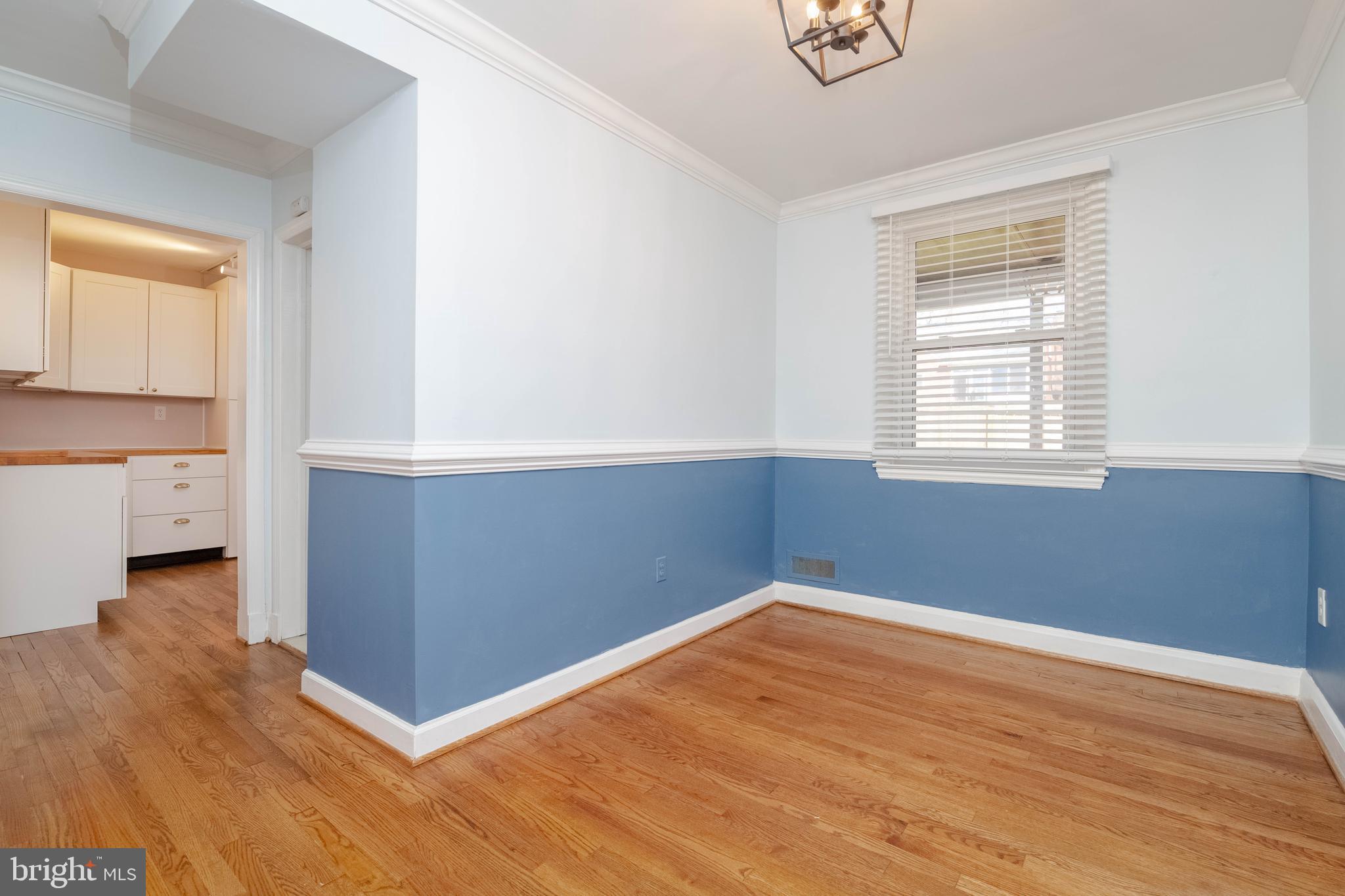 7012 Dunhill Road Dundalk, MD 21222 - Photo 10 of 38 an empty room with wooden floor and windows