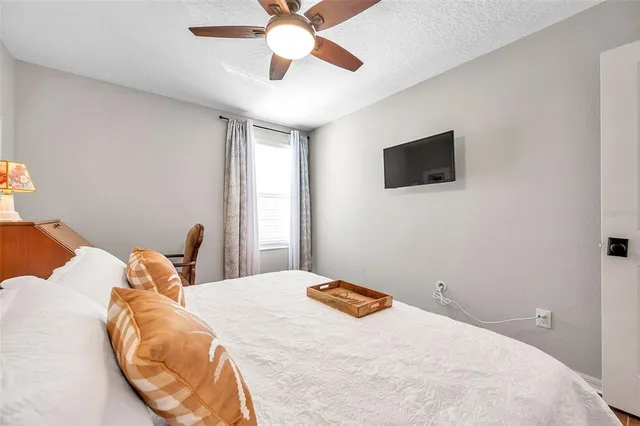 a bedroom with two beds and a large window