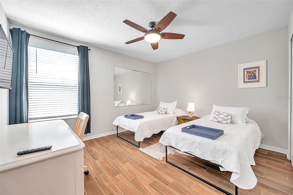 3737 Copperspring Boulevard New Port Richey, FL 34653 - Photo 13 of 61 a bedroom with two beds and a large window