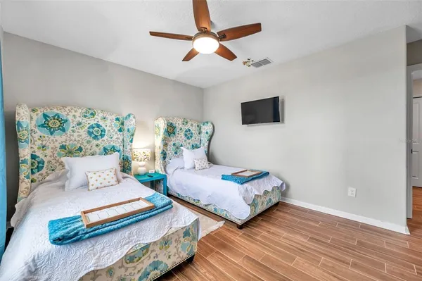 a bedroom with furniture and wooden floor