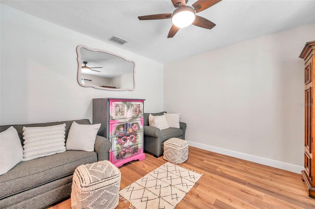3737 Copperspring Boulevard New Port Richey, FL 34653 - Photo 20 of 61 a living room with furniture and a wooden floor