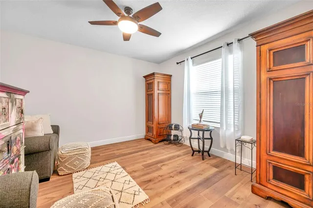 a living room with furniture a couch and a window