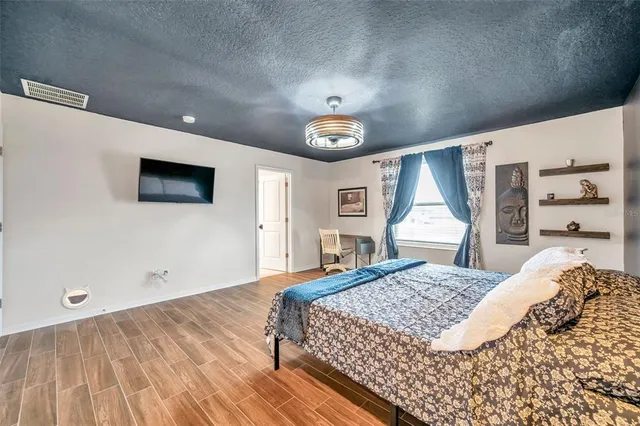 a bedroom with a large bed and a window