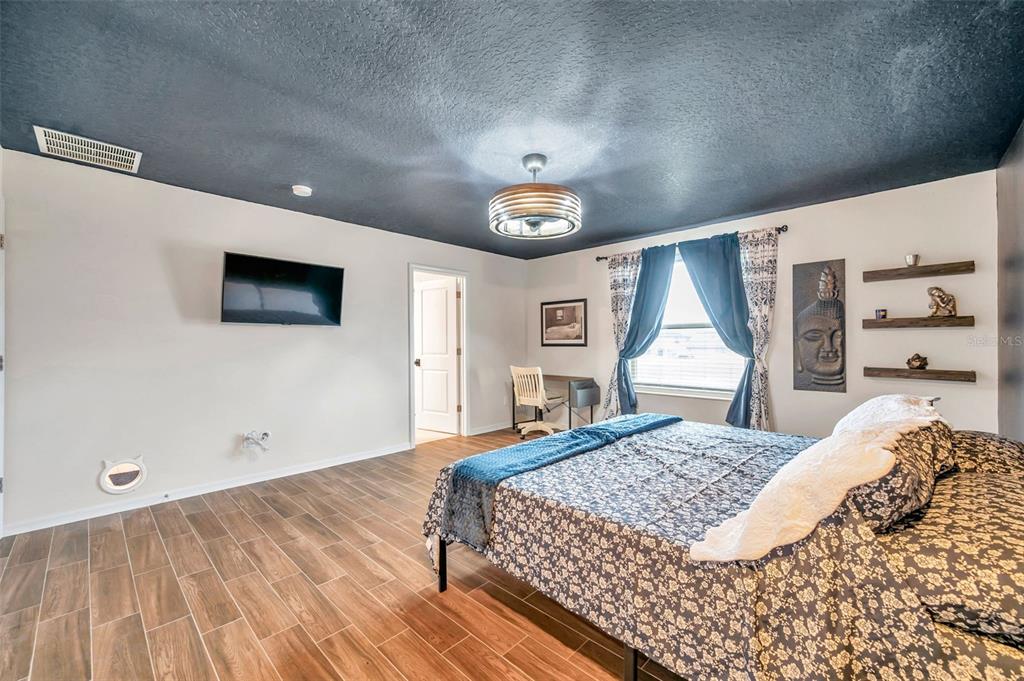 3737 Copperspring Boulevard New Port Richey, FL 34653 - Photo 3 of 61 a bedroom with a large bed and a window