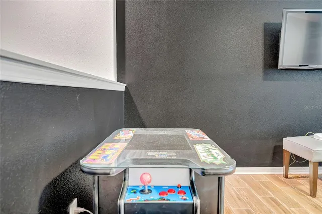 a kitchen with stainless steel appliances granite countertop a refrigerator a stove and a sink with wooden floor