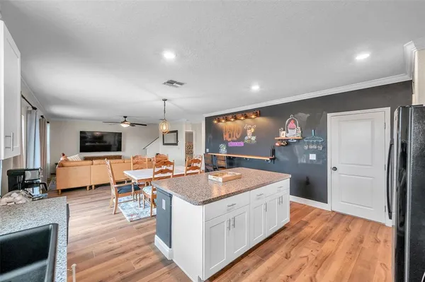 a living room with furniture a flat screen tv and a floor to ceiling window