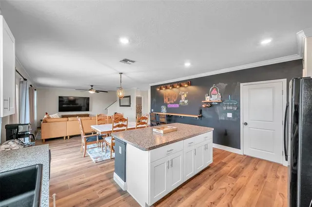a living room with furniture a flat screen tv and a floor to ceiling window
