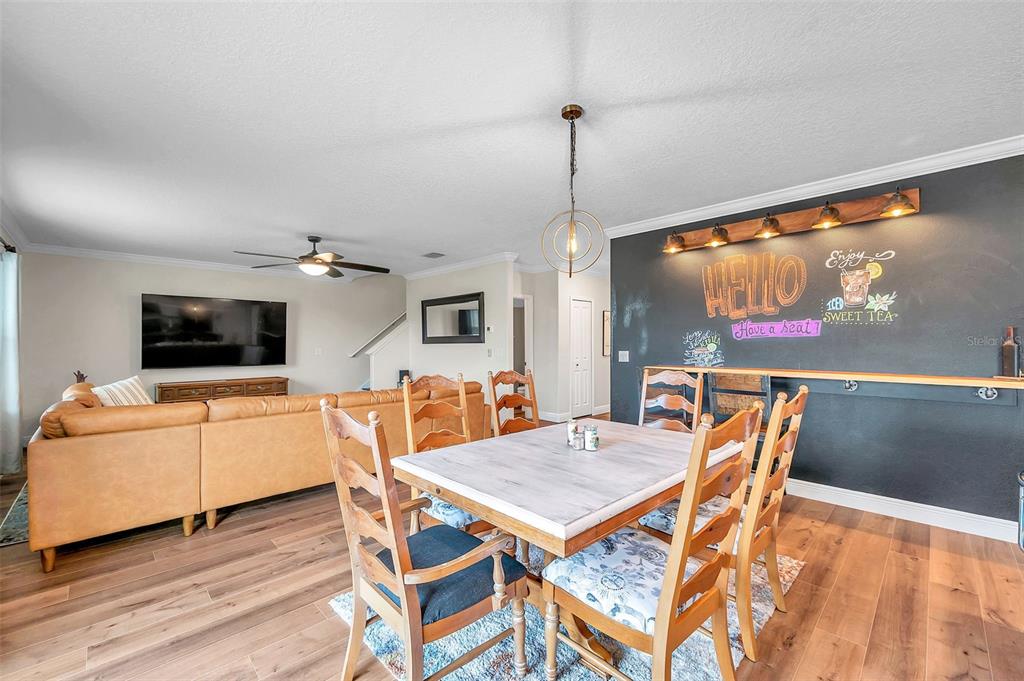 3737 Copperspring Boulevard New Port Richey, FL 34653 - Photo 41 of 61 a living room with furniture a flat screen tv and a floor to ceiling window