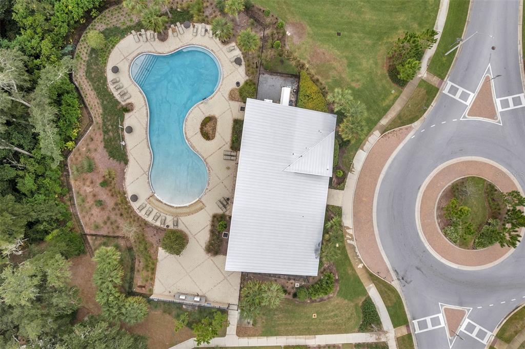 3737 Copperspring Boulevard New Port Richey, FL 34653 - Photo 59 of 61 an aerial view of a swimming pool with outdoor seating and garden