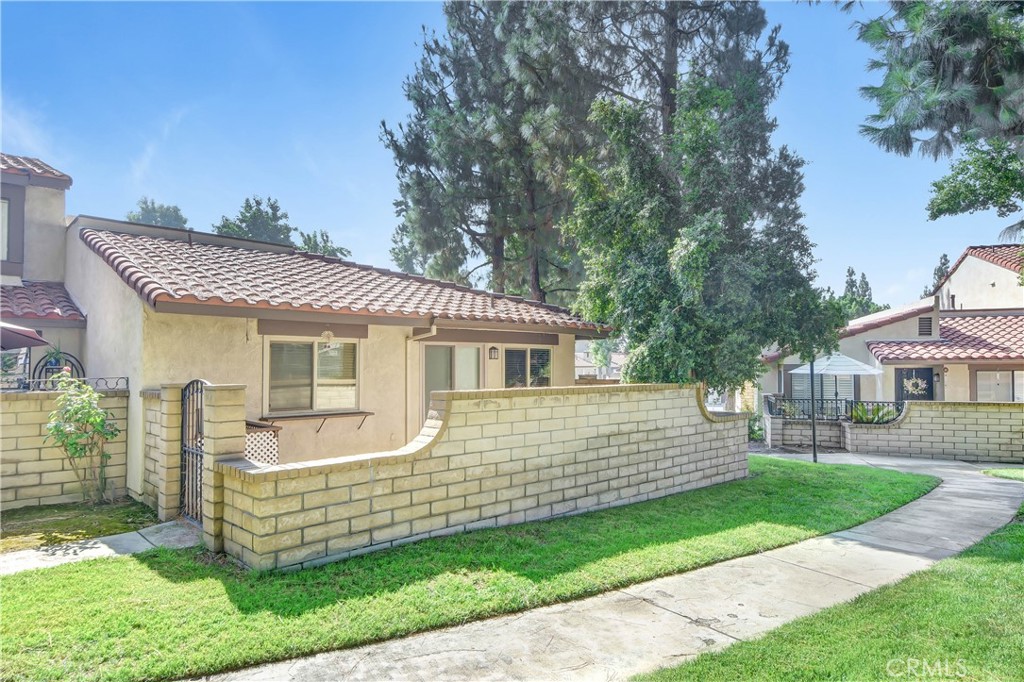 7858 Peralta Road Rancho Cucamonga, CA 91730 - Photo 14 of 14 a front view of a house with a garden