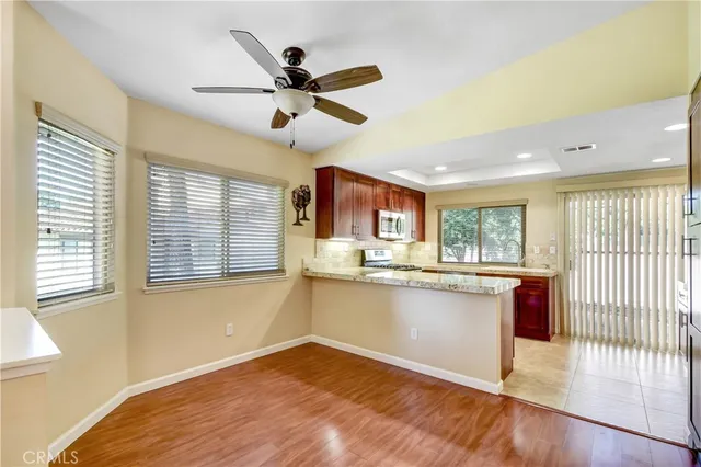 a view of a kitchen with wooden floor and a window