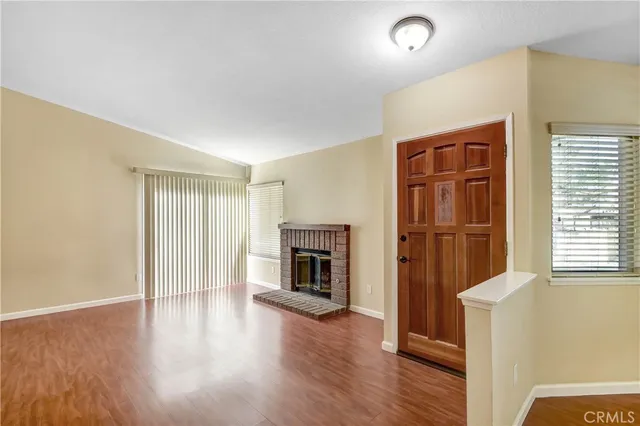 a view of a livingroom with wooden floor and fireplace