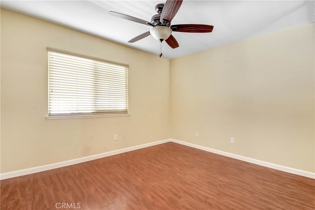 7858 Peralta Road Rancho Cucamonga, CA 91730 - Photo 10 of 14 a view of an empty room with wooden floor and a window