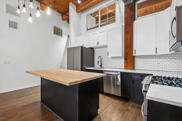 a view of walk in closet with clothes