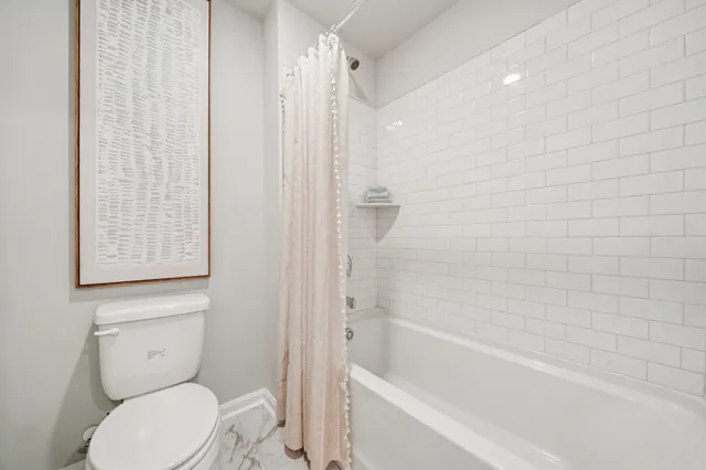 a bathroom with a toilet and shower