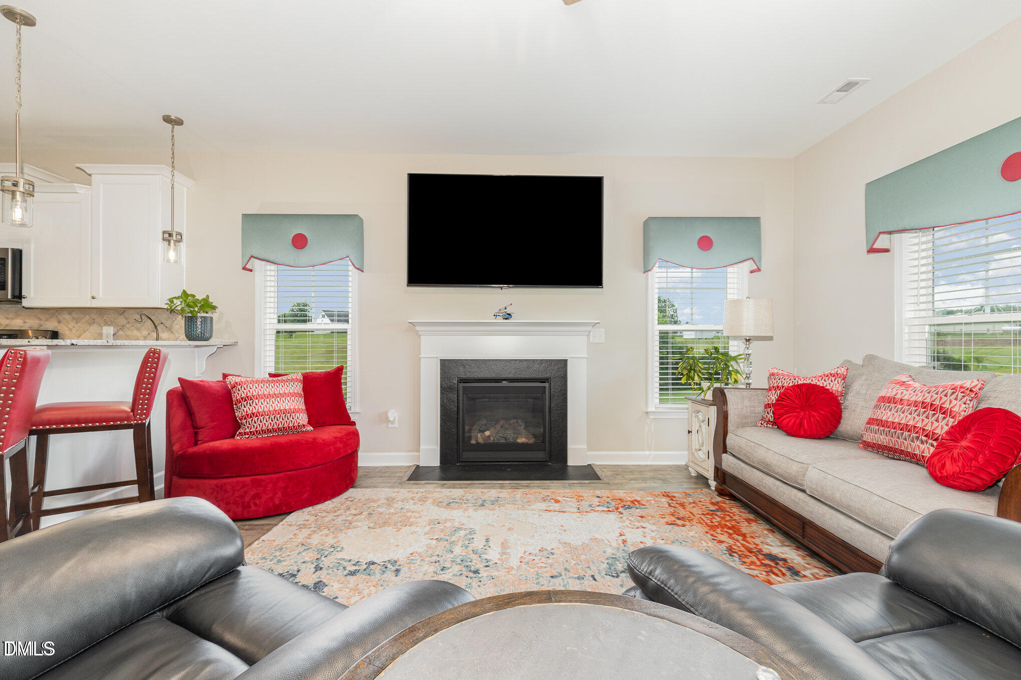 8662 Buckhorn Plantation Road Sims, NC 27880 - Photo 14 of 37 a living room with furniture a flat screen tv and a fireplace