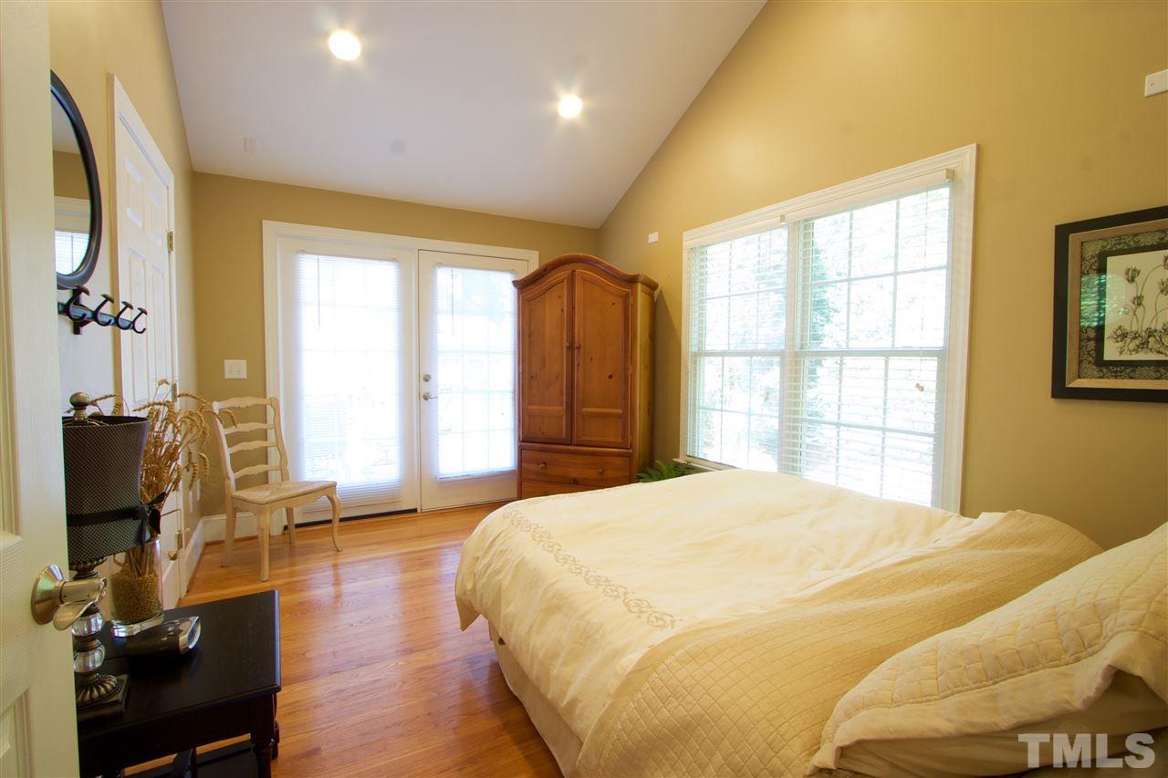 8208 Gadsen Court Raleigh, NC 27613 - Photo 14 of 25 a bedroom with a bed and wooden floor