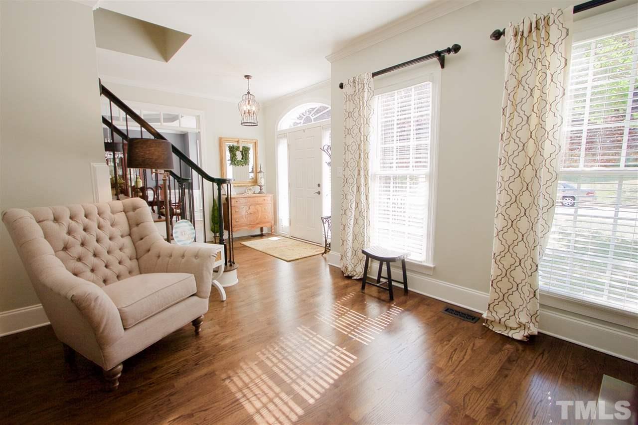 8208 Gadsen Court Raleigh, NC 27613 - Photo 4 of 25 a living room with furniture and a large window
