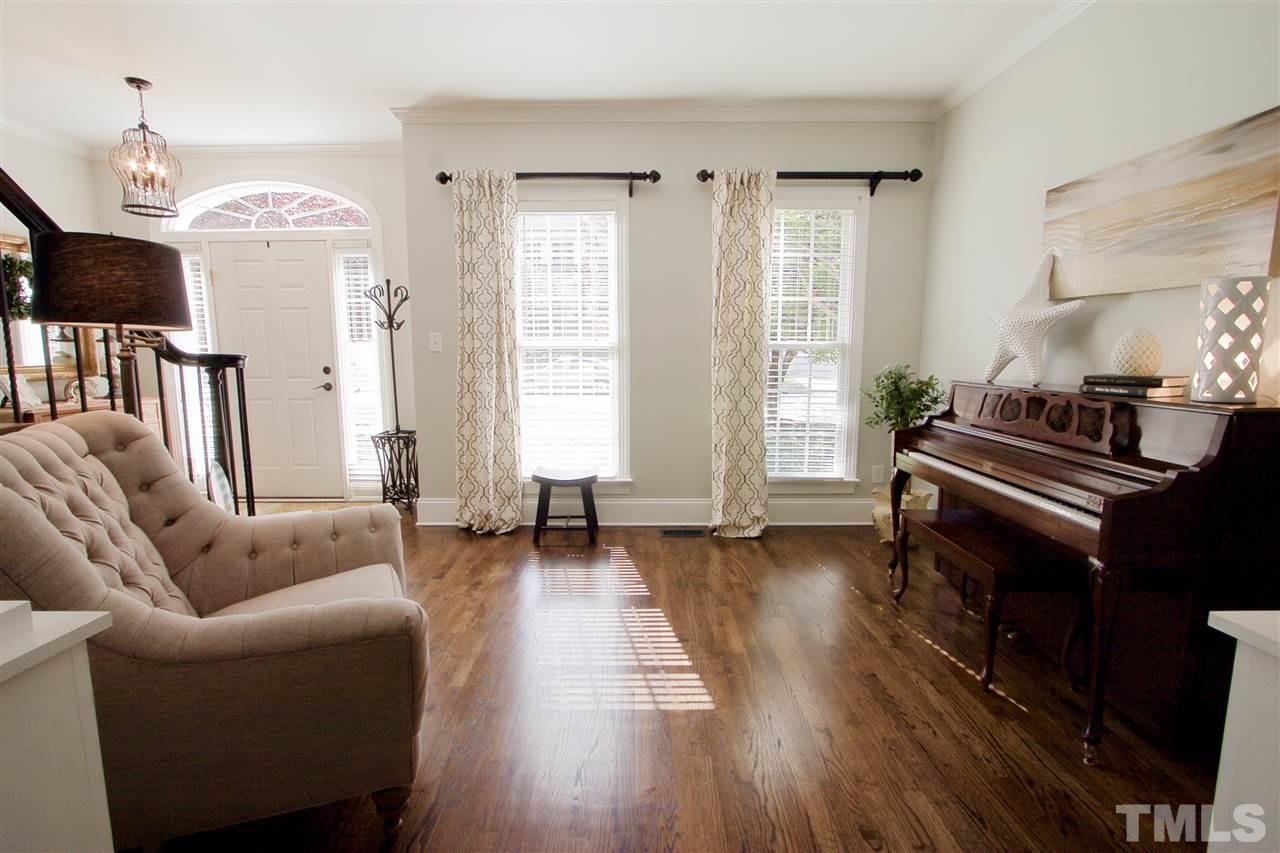 8208 Gadsen Court Raleigh, NC 27613 - Photo 5 of 25 a living room with furniture and a fireplace